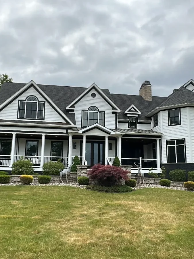 Clean dark asphalt roof on a white colonial in Dutchess County after a roof soft wash