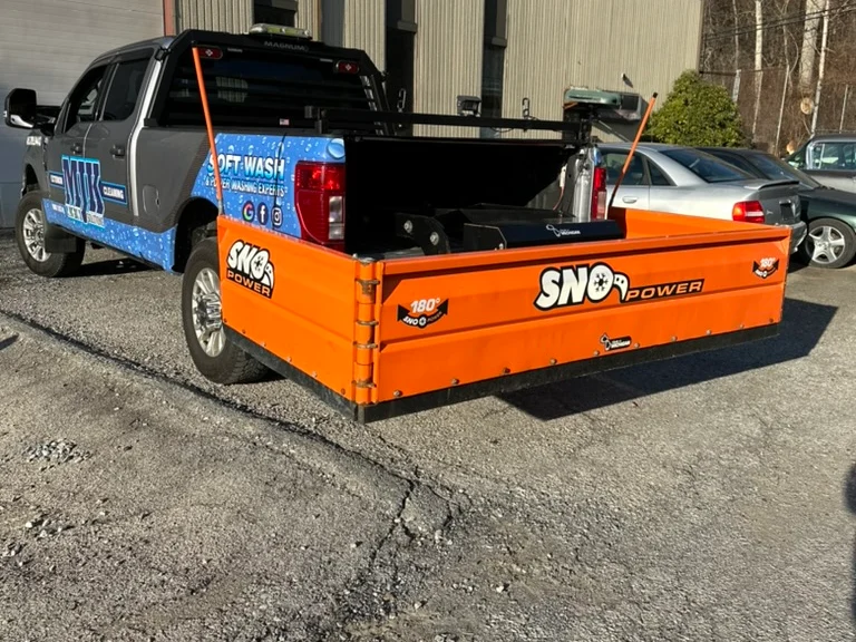MJK Solutions black plow truck with a rear box plow ready for a commercial lot in Poughkeepsie, NY