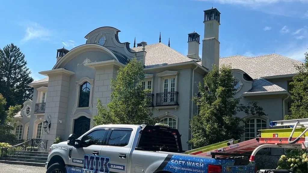 MJK Solutions soft wash truck parked in front of a stone estate home during an exterior cleaning, Hudson Valley NY