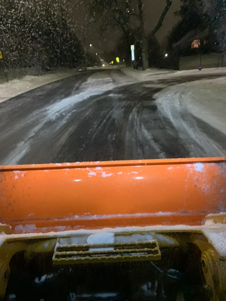 View from the MJK Solutions plow truck cab while plowing a commercial lot during a night snowstorm in Poughkeepsie, NY
